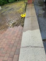 back garden wall cleaning showing moss removal in garden