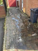 driveway in process of cleaning beside bin